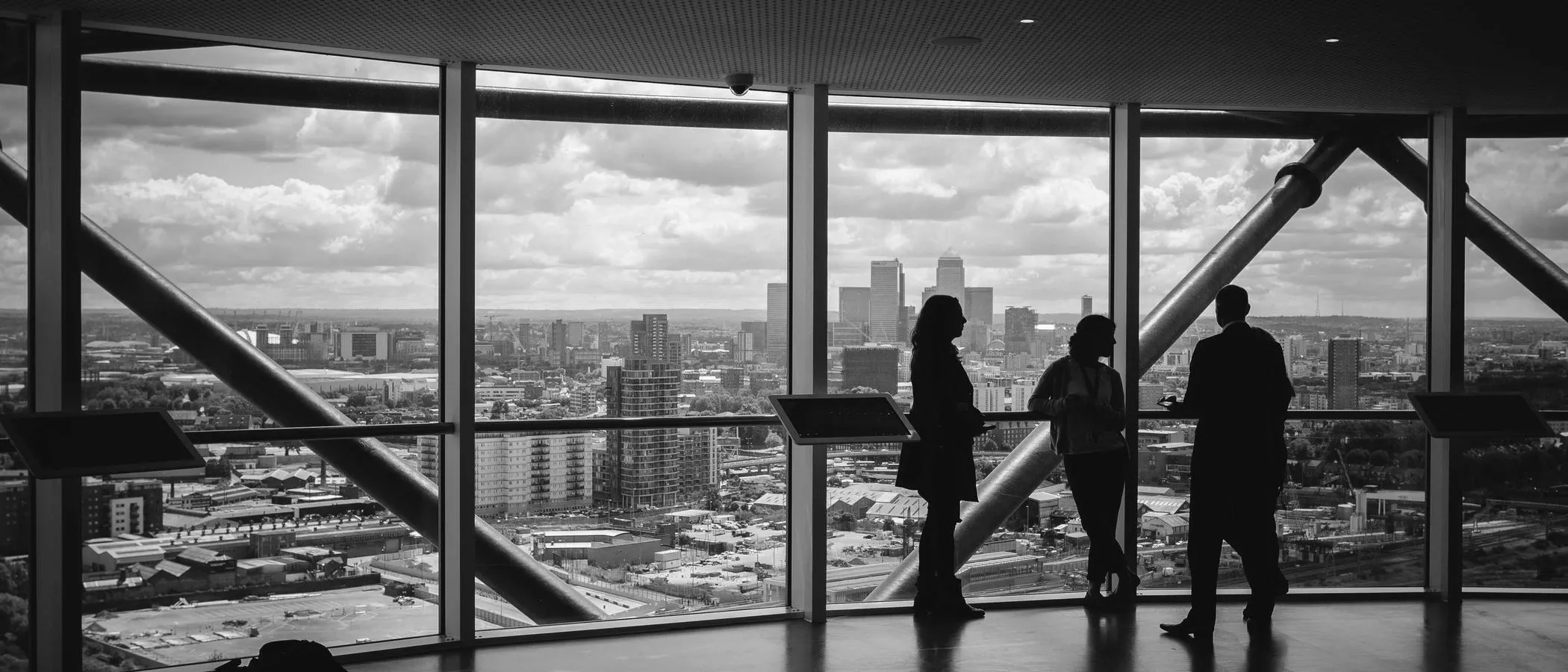 Two people looking out over a city from a window