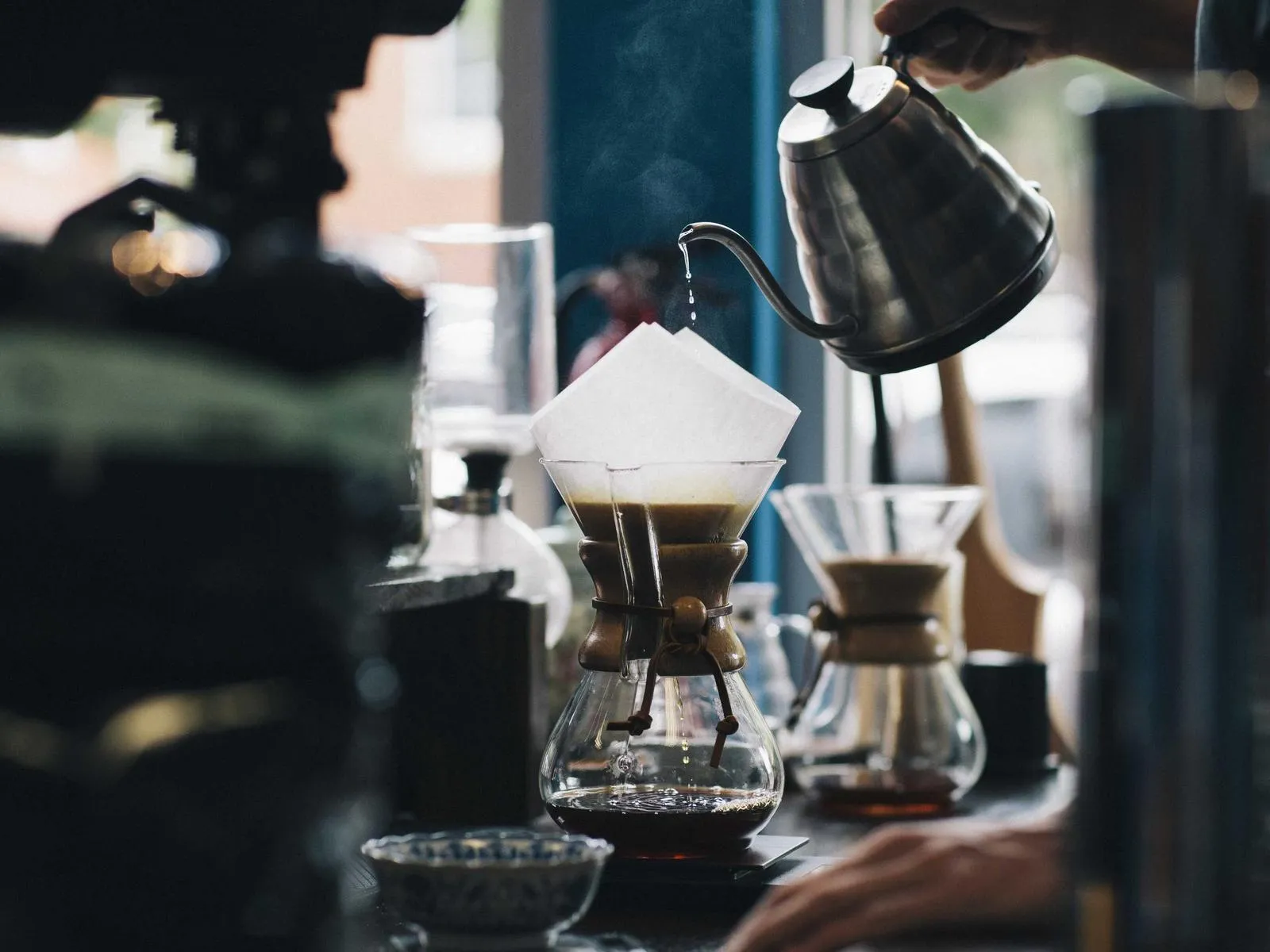 Barista pouring coffee at a counter (placeholder)