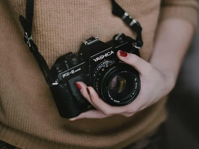 Hands holding a film camera (placeholder)