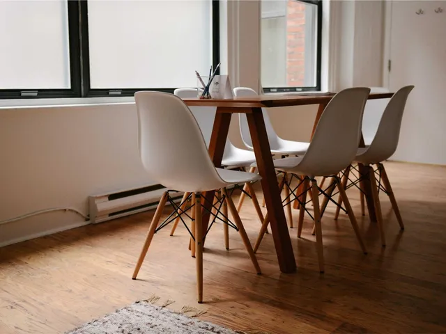 Bright dining room with wooden table (placeholder)