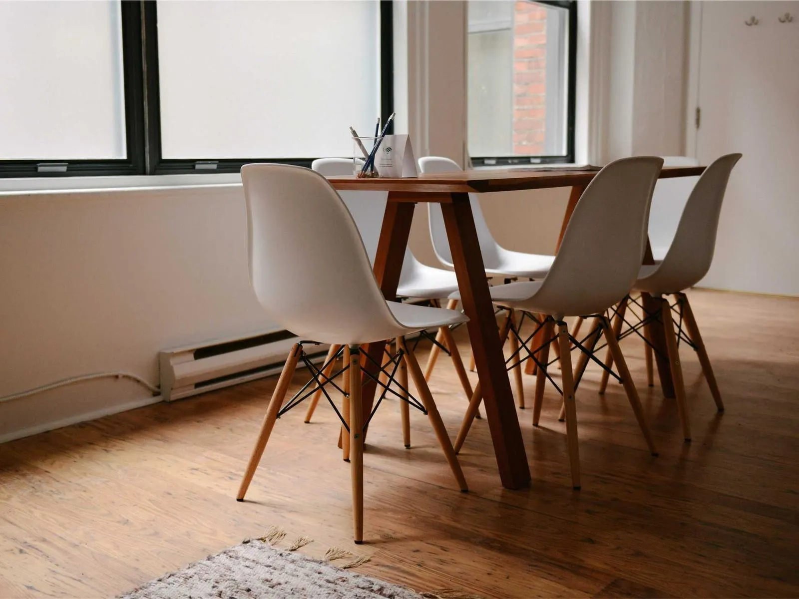 Bright dining room with wooden table (placeholder)