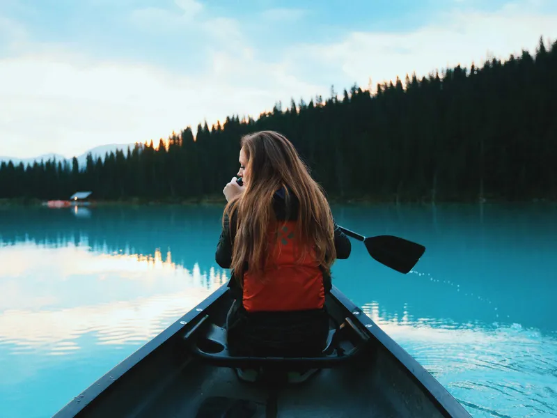Person paddling a canoe on a mountain lake (placeholder)